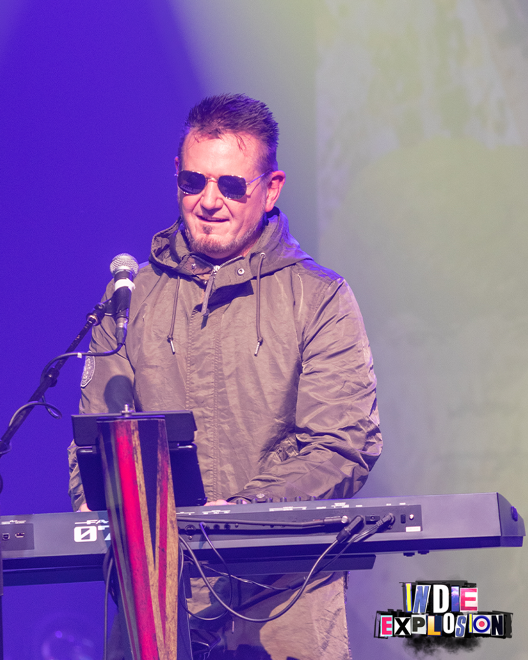 keyboard player dressed in parka and glasses at indie explosion